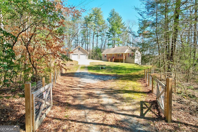 view of road with a gated entry and driveway