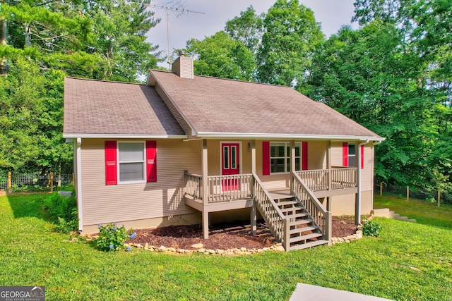 view of front of property with a front lawn, stairway, covered porch, a shingled roof, and a chimney