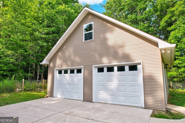 detached garage featuring fence