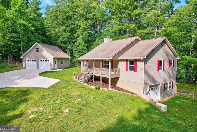 view of front of property with a front yard, a porch, a chimney, an outdoor structure, and a detached garage