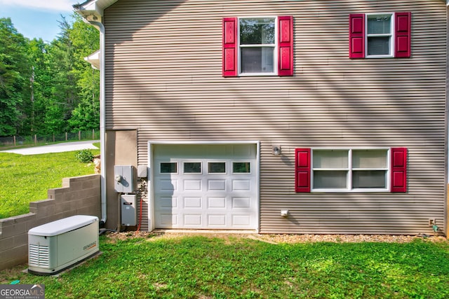 view of side of home featuring a garage and a yard