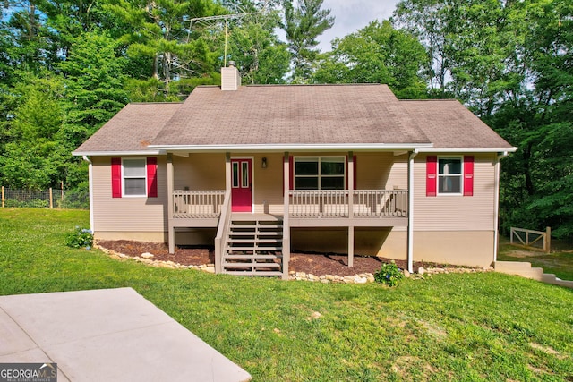 ranch-style house featuring fence, stairway, a front yard, covered porch, and a chimney