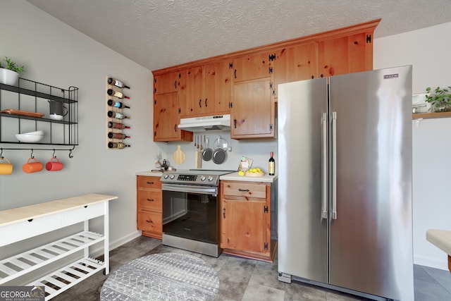 kitchen featuring under cabinet range hood, appliances with stainless steel finishes, a textured ceiling, and light countertops