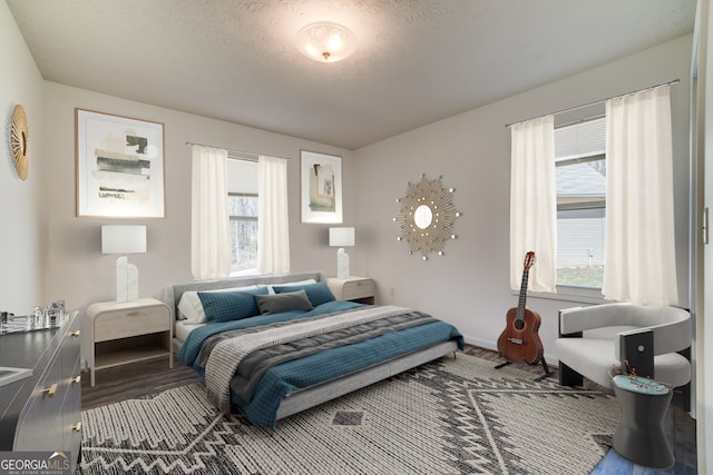 bedroom featuring a textured ceiling and wood finished floors