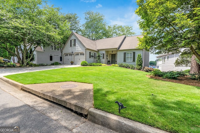 view of front of property featuring a front yard and a garage