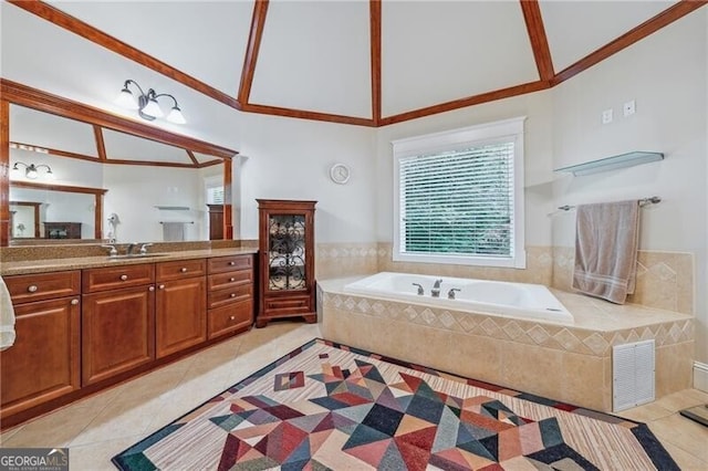 bathroom with tile patterned flooring, vaulted ceiling, and vanity