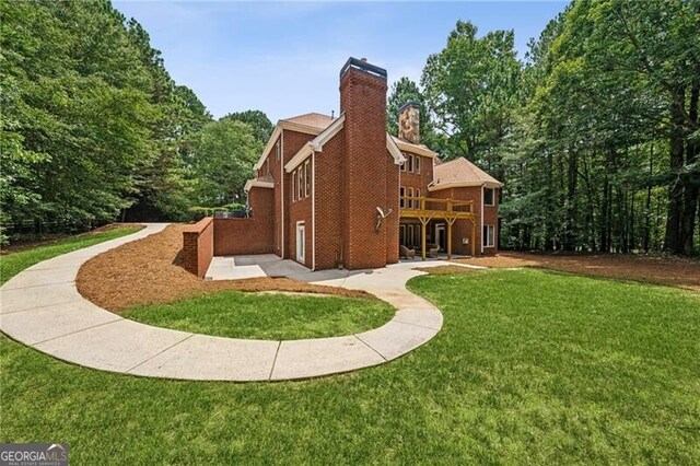 back of house featuring a yard and a patio area