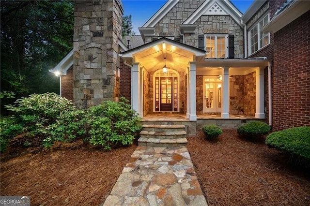 doorway to property featuring covered porch