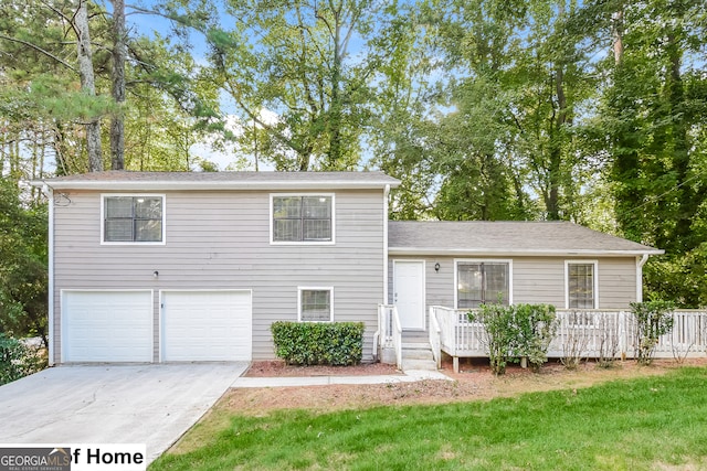 split level home with a front yard and a garage