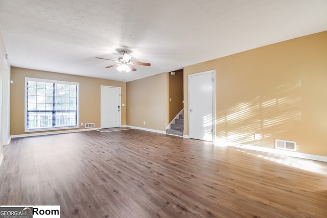 spare room with hardwood / wood-style floors, ceiling fan, and a textured ceiling