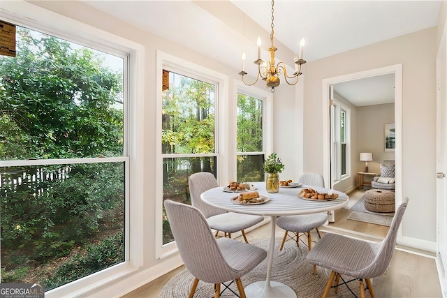 sunroom with an inviting chandelier