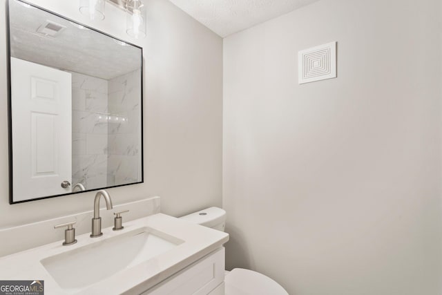 full bathroom with visible vents, a shower, toilet, a textured ceiling, and vanity