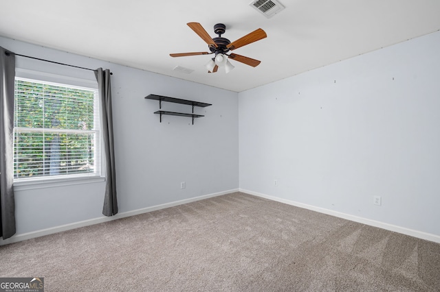 carpeted empty room featuring ceiling fan