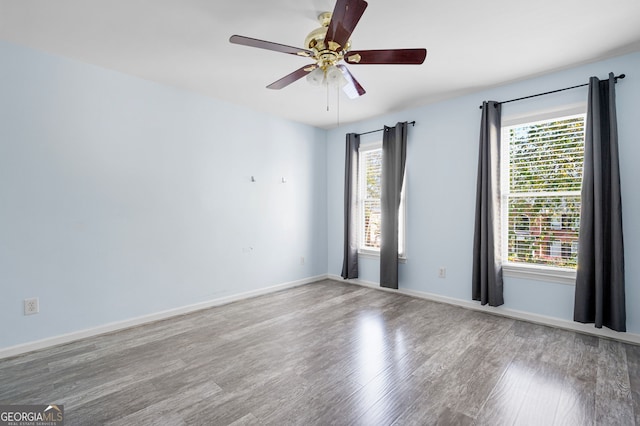 spare room with hardwood / wood-style flooring and ceiling fan