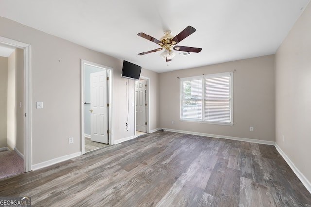 unfurnished bedroom featuring hardwood / wood-style flooring and ceiling fan