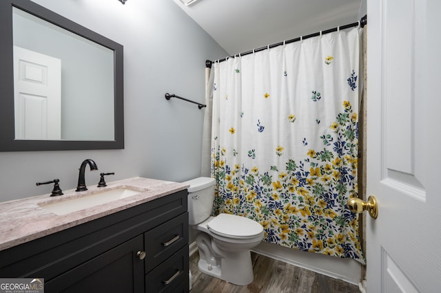 full bathroom featuring vanity, toilet, shower / tub combo with curtain, and hardwood / wood-style floors