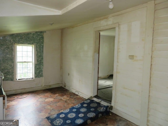 empty room with lofted ceiling