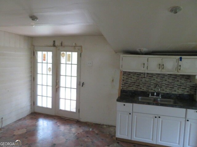 kitchen with sink, white cabinetry, backsplash, a wealth of natural light, and french doors