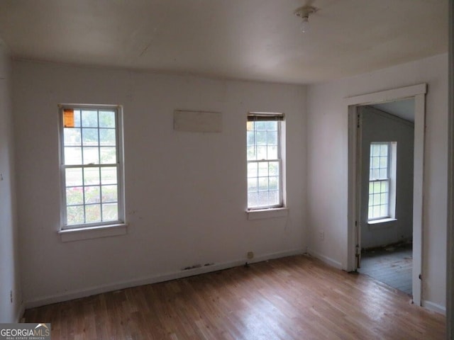 empty room with a healthy amount of sunlight and light wood-type flooring