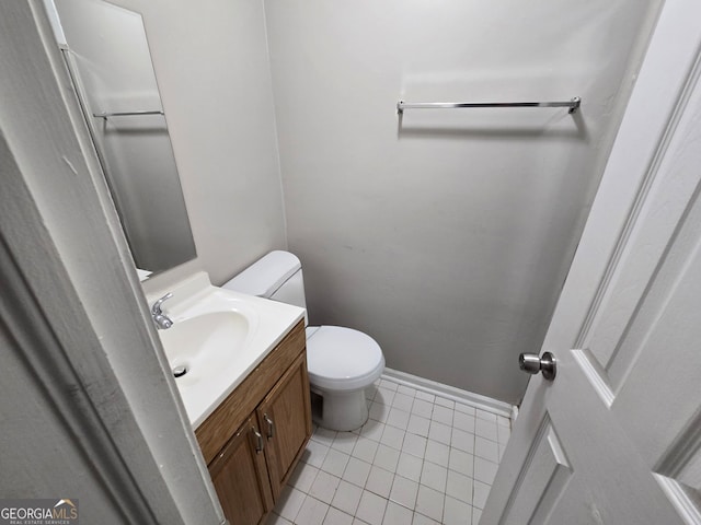 bathroom featuring tile patterned floors, vanity, and toilet