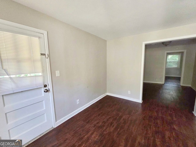 unfurnished room featuring dark hardwood / wood-style flooring