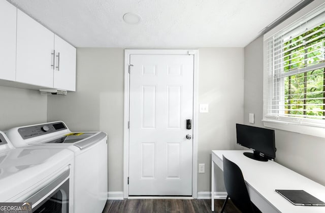 laundry room with dark wood-type flooring, cabinets, plenty of natural light, and washing machine and dryer