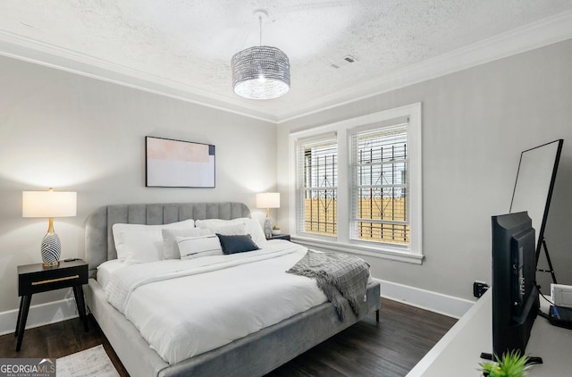 bedroom featuring dark wood-type flooring, a textured ceiling, and crown molding