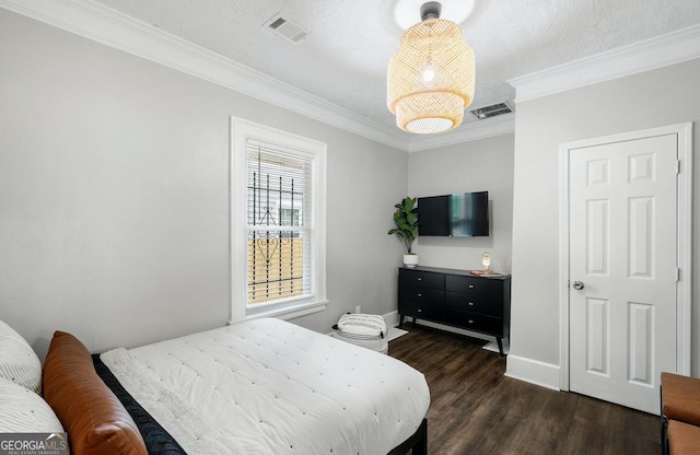 bedroom featuring dark wood-type flooring, ornamental molding, and a textured ceiling