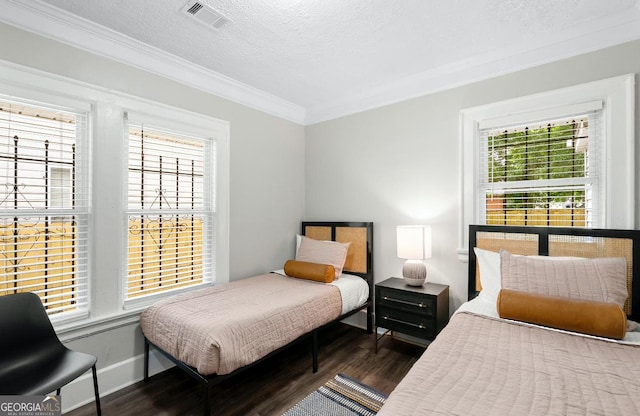 bedroom with a textured ceiling, ornamental molding, dark hardwood / wood-style floors, and multiple windows