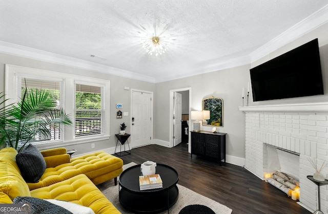 living room with a textured ceiling, dark hardwood / wood-style floors, crown molding, and a fireplace