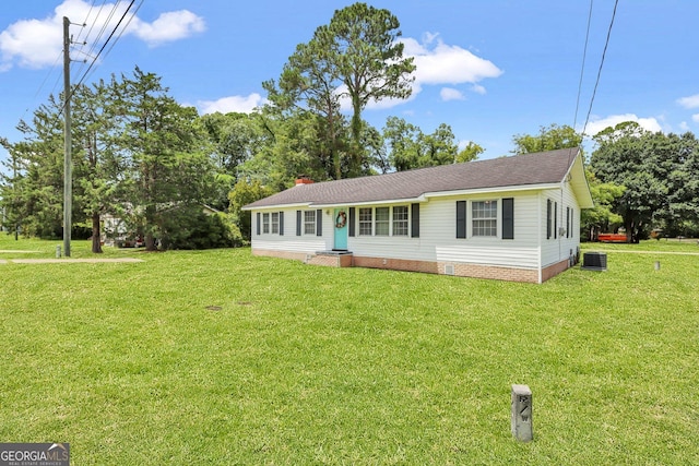 ranch-style house featuring central AC unit and a front lawn