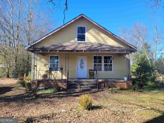 bungalow-style home with a front yard and a porch