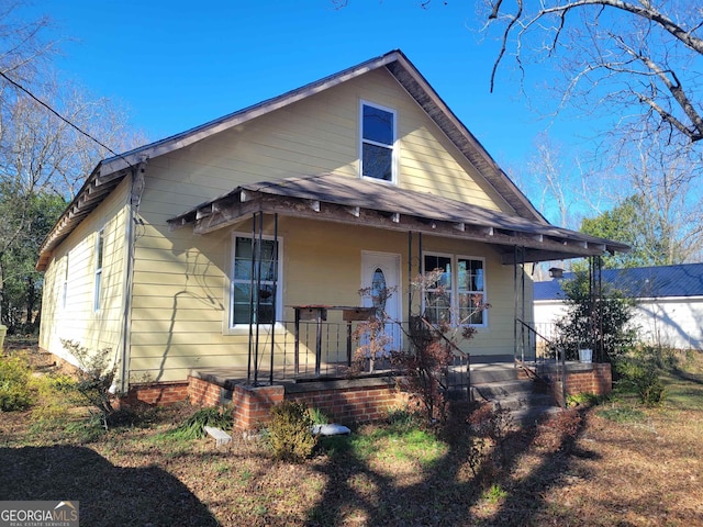 exterior space featuring a lawn and covered porch