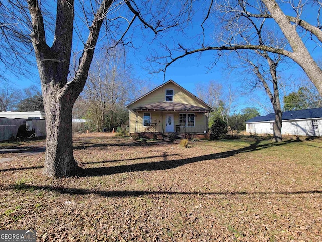 rear view of property featuring a porch