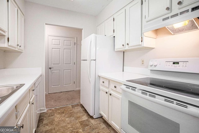 kitchen with white appliances and white cabinets