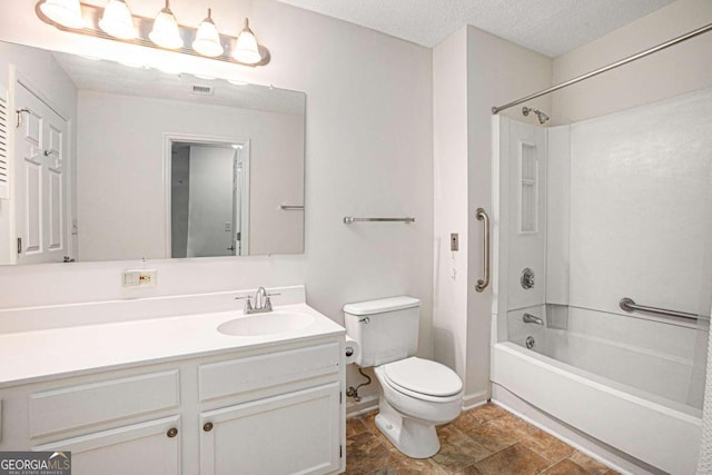 full bathroom featuring vanity, bathtub / shower combination, toilet, and a textured ceiling