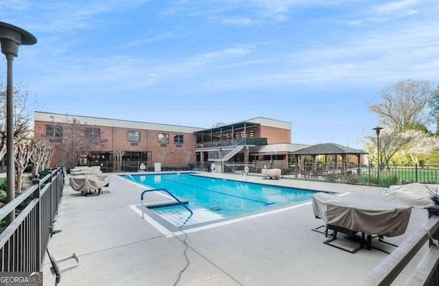 view of swimming pool with a gazebo, a grill, and a patio area