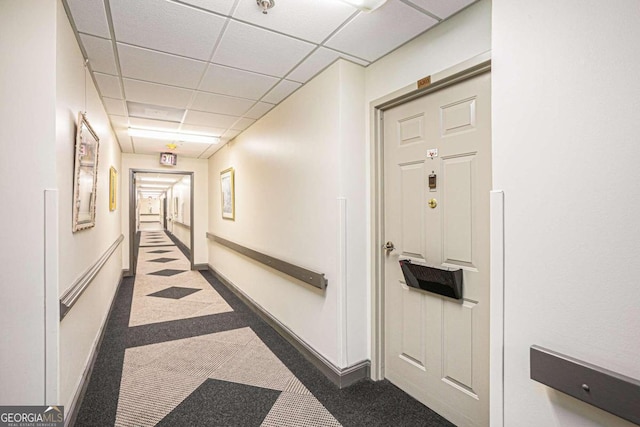 hallway featuring a paneled ceiling