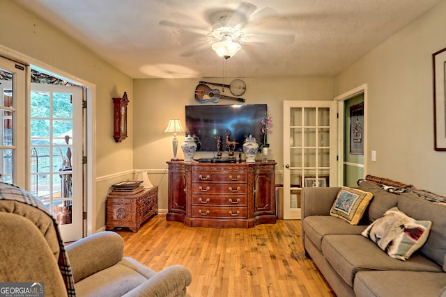 living room with ceiling fan, light hardwood / wood-style flooring, and a healthy amount of sunlight