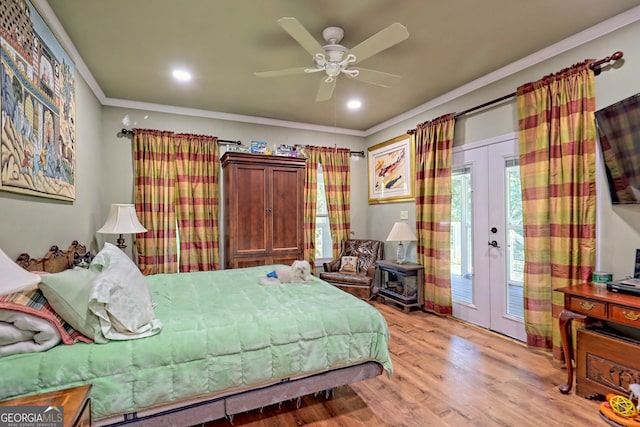 bedroom featuring crown molding, light hardwood / wood-style floors, french doors, and access to exterior