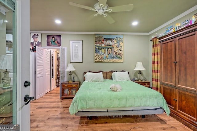 bedroom featuring ornamental molding, ceiling fan, light hardwood / wood-style floors, and a closet