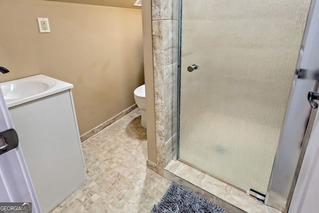 bathroom featuring tile patterned floors, toilet, vanity, and an enclosed shower