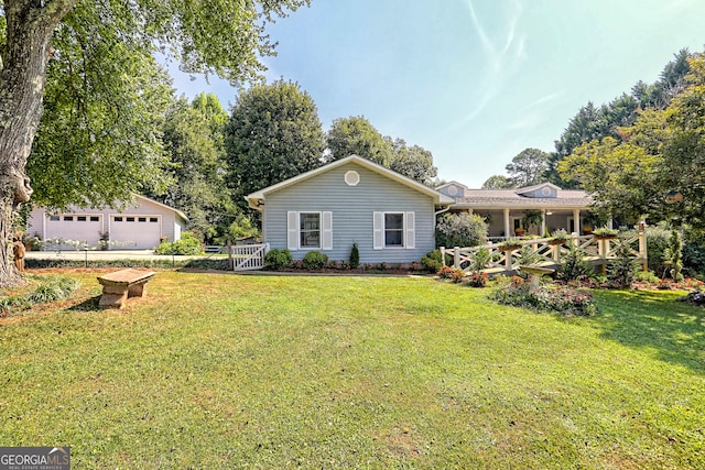 back of property featuring a garage and a lawn