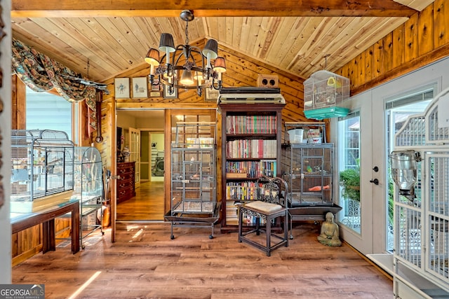 sitting room featuring an inviting chandelier, lofted ceiling with beams, hardwood / wood-style floors, and wood ceiling