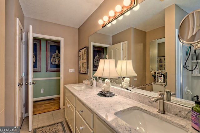 bathroom featuring hardwood / wood-style flooring and dual bowl vanity