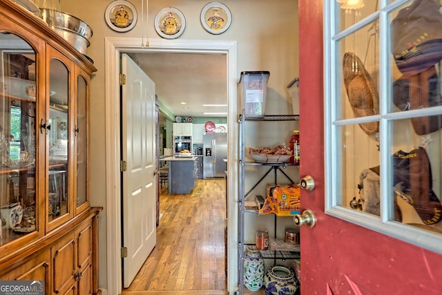 hall with light hardwood / wood-style flooring