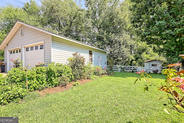 exterior space featuring a garage and an outbuilding