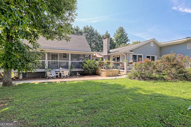 back of property with a patio and a lawn