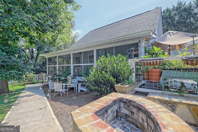 view of patio with a sunroom