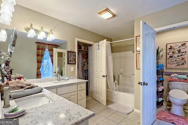 full bathroom with tile patterned flooring, dual bowl vanity, a textured ceiling, toilet, and shower / bath combo with shower curtain